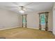 Neutral bedroom with two windows, a ceiling fan, and carpeted floors providing a serene atmosphere at 185 Downybrook Ln, Fayetteville, GA 30215