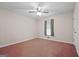 Simple bedroom with ceiling fan, single window and neutral walls, a comfortable and serene retreat at 185 Downybrook Ln, Fayetteville, GA 30215