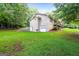 Beautifully maintained property featuring a garage door, well manicured lawn, and plenty of trees at 185 Downybrook Ln, Fayetteville, GA 30215