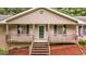 Cozy front porch with hanging planters and black shutters, leading to a welcoming entrance at 185 Downybrook Ln, Fayetteville, GA 30215