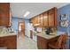 Traditional kitchen features wood cabinets, mosaic backsplash, and granite countertops with breakfast bar seating at 185 Downybrook Ln, Fayetteville, GA 30215
