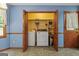 Convenient laundry room with washer, dryer, and storage shelves, accessible through louvered doors at 185 Downybrook Ln, Fayetteville, GA 30215