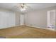 A serene main bedroom with carpeting, ceiling fan, and ensuite bathroom at 185 Downybrook Ln, Fayetteville, GA 30215