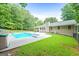 Beautiful in-ground pool surrounded by a patio and lush greenery, perfect for relaxation and outdoor entertainment at 185 Downybrook Ln, Fayetteville, GA 30215