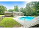 Backyard view showcases the in-ground pool, patio area, and the home's exterior siding at 185 Downybrook Ln, Fayetteville, GA 30215