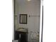 Small bathroom with toilet, sink, mirror, and towel rack at 101 Pinetree Trl, Atlanta, GA 30349