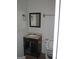 Compact bathroom with a sink, mirror, and toilet, offering essential fixtures at 101 Pinetree Trl, Atlanta, GA 30349