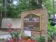 Pine Tree Condominiums brick signage surrounded by greenery and flowers at 101 Pinetree Trl, Atlanta, GA 30349