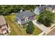 Aerial view of a charming two-story home surrounded by lush greenery and a well-kept lawn at 1209 Polk Xing, Mcdonough, GA 30252