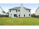 Large, well-maintained backyard with green lawn, patio, and a view of the home's rear facade at 1209 Polk Xing, Mcdonough, GA 30252