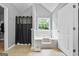 The primary bathroom features a bathtub with a window and a separate room for the commode at 1209 Polk Xing, Mcdonough, GA 30252