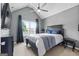 A bedroom showing a bed with blue pillows and a black frame, with a window for natural light at 1209 Polk Xing, Mcdonough, GA 30252