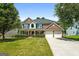Beautiful two-story brick home with a well-manicured lawn and a two-car garage at 1209 Polk Xing, Mcdonough, GA 30252