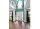 Inviting foyer with a high ceiling, hardwood floors, and a view of the upper level at 1209 Polk Xing, Mcdonough, GA 30252