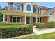 Close-up view of the brick home's front porch with decorative shrubbery and number 1209 at 1209 Polk Xing, Mcdonough, GA 30252