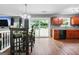 Eat-in kitchen features wood floors, a dining table and sliding glass doors to the backyard at 1209 Polk Xing, Mcdonough, GA 30252