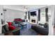 Comfortable living room with a fireplace, flat screen TV, plush seating, and stylish decor at 1209 Polk Xing, Mcdonough, GA 30252