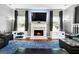 Bright living room featuring a fireplace and a TV and large windows at 1209 Polk Xing, Mcdonough, GA 30252