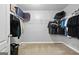 A spacious walk-in closet with shelving and rod space for storage, laundry basket, and a suitcase at 1209 Polk Xing, Mcdonough, GA 30252