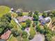 Aerial view showcasing the property's layout with a driveway, lush landscaping, and proximity to the lake at 2775 Club Valley Ct, Jonesboro, GA 30236