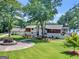 Aerial view of a beautiful property with lush green lawns, mature trees, and a lovely home near the water at 2775 Club Valley Ct, Jonesboro, GA 30236