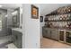 Stylish home bar area featuring custom shelving and a convenient beverage refrigerator at 2775 Club Valley Ct, Jonesboro, GA 30236