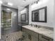 Modern bathroom featuring stylish gray tiling, a glass-enclosed shower, and a granite vanity at 2775 Club Valley Ct, Jonesboro, GA 30236