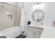 This stylish bathroom boasts a shower and tub combination and a modern vanity with a decorative mirror at 2775 Club Valley Ct, Jonesboro, GA 30236