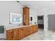 Bathroom featuring double vanities, white countertops, and wooden cabinets with modern, illuminated mirrors at 2775 Club Valley Ct, Jonesboro, GA 30236