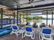 Covered boat dock featuring multiple boat slips, personal watercraft ramps, lounge chairs, and a ceiling fan at 2775 Club Valley Ct, Jonesboro, GA 30236