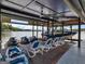 Lakefront boat dock with boat lifts, personal watercraft ramps, lounge chairs, and a ceiling fan at 2775 Club Valley Ct, Jonesboro, GA 30236