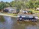 Lakeside view of a home with a private boathouse and lush landscaping at 2775 Club Valley Ct, Jonesboro, GA 30236