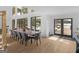 Elegant dining room with a large table, modern chairs, and expansive windows offering picturesque outdoor views at 2775 Club Valley Ct, Jonesboro, GA 30236