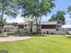 Expansive estate with lush greenery, stately trees, circular driveway, and stunning home with wood and white brick at 2775 Club Valley Ct, Jonesboro, GA 30236