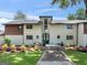 Charming home with a well-maintained lawn, stone walkway, and beautiful landscaping at 2775 Club Valley Ct, Jonesboro, GA 30236