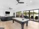 Spacious game room offering a pool table, comfortable seating, and scenic lake views through large sliding doors at 2775 Club Valley Ct, Jonesboro, GA 30236