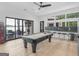 Game room featuring a pool table, bar area with seating, and sliding doors offering lake views and outdoor access at 2775 Club Valley Ct, Jonesboro, GA 30236