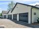 Four-car garage with black doors and white exterior, offering ample parking and storage space at 2775 Club Valley Ct, Jonesboro, GA 30236