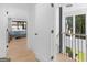 Bright hallway with hardwood floors offers access to a bedroom with lake views and a staircase to the upper level at 2775 Club Valley Ct, Jonesboro, GA 30236