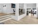 Inviting hallway featuring elegant flooring, stair steps, and a glimpse into the recreational spaces and waterfront views at 2775 Club Valley Ct, Jonesboro, GA 30236