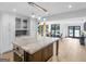 Modern kitchen boasts sleek white cabinets, a marble island, and views of the outdoor dining area at 2775 Club Valley Ct, Jonesboro, GA 30236