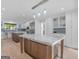 Spacious kitchen features white cabinetry, stainless steel appliances, and a large marble island at 2775 Club Valley Ct, Jonesboro, GA 30236