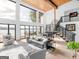 Modern living room features soaring ceilings, large windows with lake views, and a sleek staircase at 2775 Club Valley Ct, Jonesboro, GA 30236