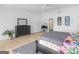 Bright main bedroom featuring a dresser, hardwood floors, and an area rug at 2775 Club Valley Ct, Jonesboro, GA 30236