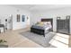 Bright main bedroom featuring a bed with drawers, ceiling fan, area rug, and hardwood floors at 2775 Club Valley Ct, Jonesboro, GA 30236