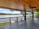 Covered patio featuring a ceiling fan, wood ceiling, and lake view at 2775 Club Valley Ct, Jonesboro, GA 30236