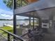 Covered patio area featuring a brick floor, lake views, and a comfortable seating area perfect for entertaining at 2775 Club Valley Ct, Jonesboro, GA 30236