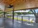 Covered patio featuring a ceiling fan, wood ceiling, and lake view at 2775 Club Valley Ct, Jonesboro, GA 30236