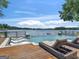Beautiful lake view from an infinity pool featuring a jacuzzi and lounge chairs on a wooden deck at 2775 Club Valley Ct, Jonesboro, GA 30236