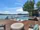Outdoor deck area with a pool, jacuzzi, lounge seating, and stunning lake views for relaxation and entertainment at 2775 Club Valley Ct, Jonesboro, GA 30236